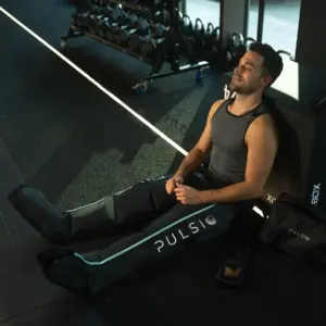 man wearing pulsio boots in gym