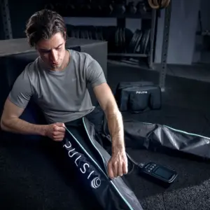 man putting pulsio boots on